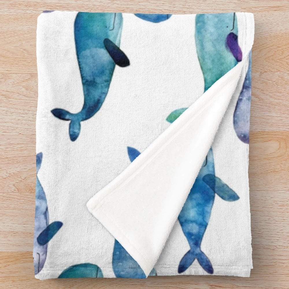 Soft, cozy plush blanket featuring vibrant watercolor whales