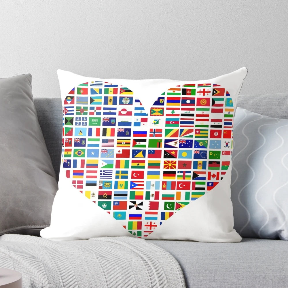 Colorful heart-shaped pillow featuring flags from countries around the world