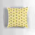 A yellow and black patterned pillow featuring a repeating bumble bee design