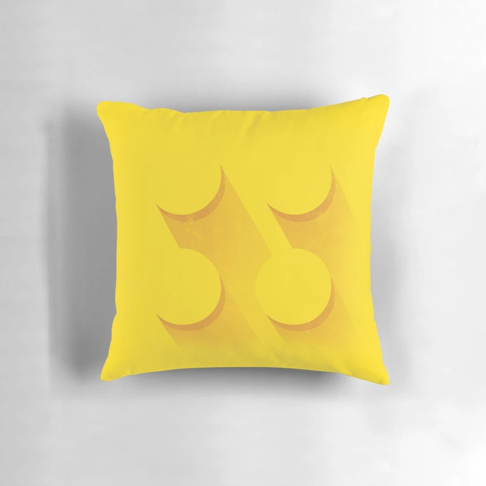 Closeup image of a yellow brick-inspired pillow with a minimalist, LEGO-inspired design.