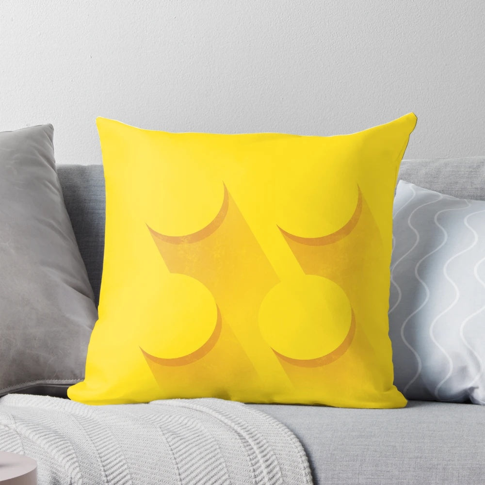 Closeup image of a yellow brick-inspired pillow with a minimalist, LEGO-inspired design.