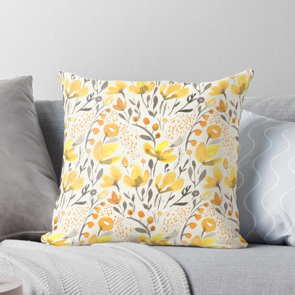 Colorful watercolor-style yellow flowers and foliage on a throw pillow