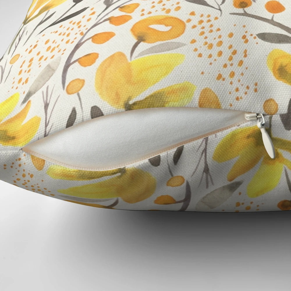 Colorful watercolor-style yellow flowers and foliage on a throw pillow
