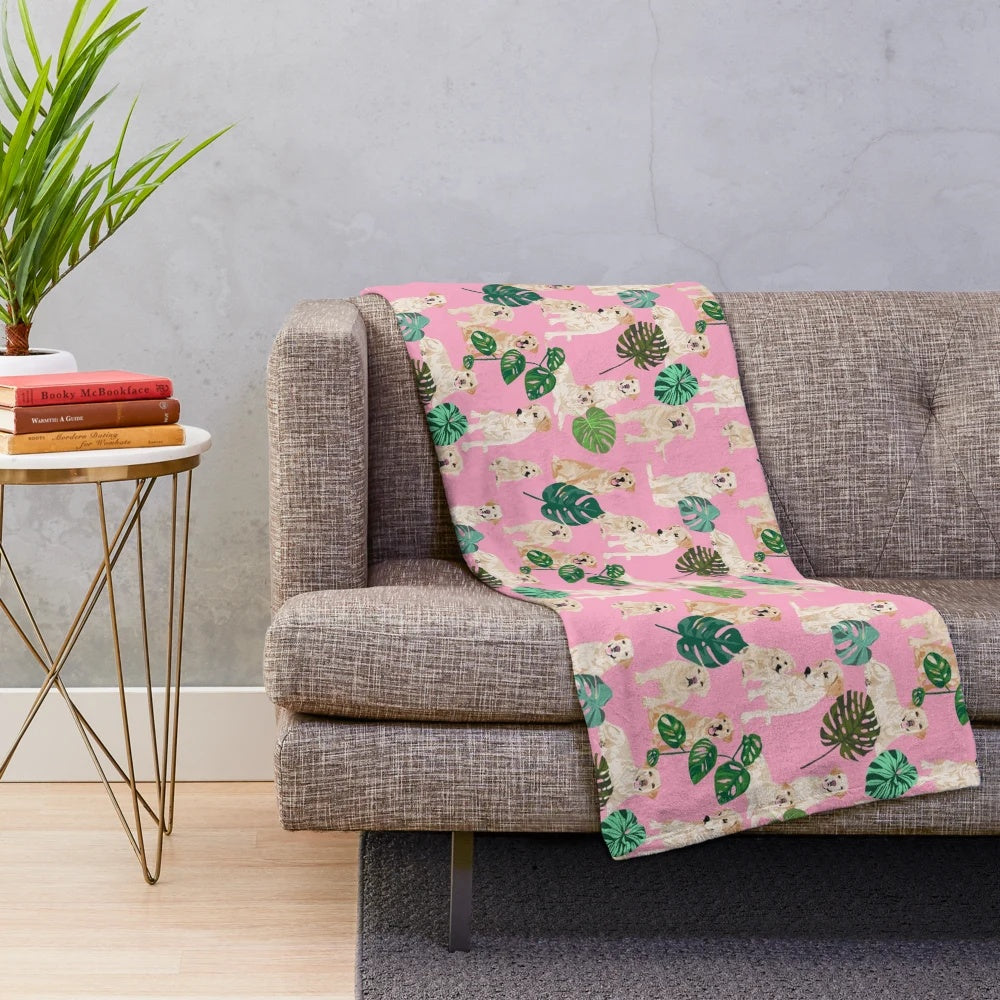 Yellow labrador retriever dog breed on a tropical pink plush blanket