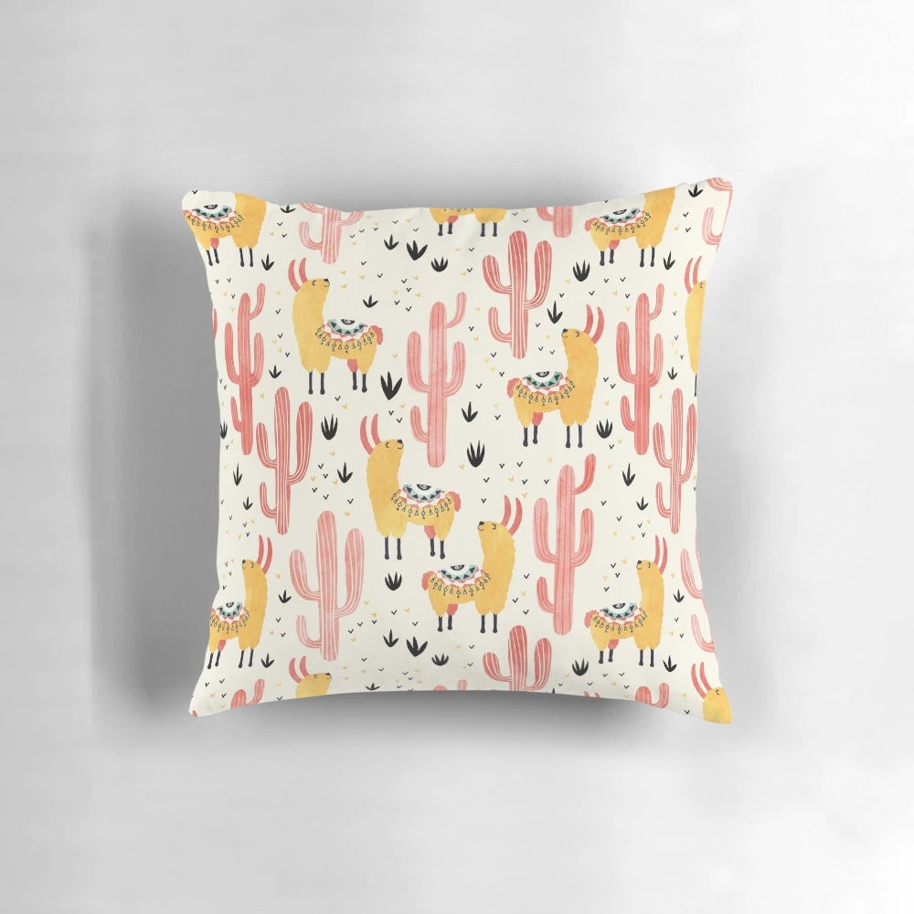 Colorful throw pillow featuring a whimsical yellow llama and red cacti design