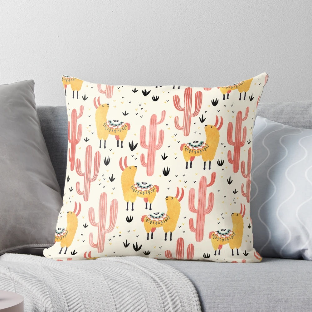 Colorful throw pillow featuring a whimsical yellow llama and red cacti design
