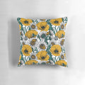 Close-up image of a decorative pillow featuring a vibrant yellow and white floral pattern inspired by a countryside meadow.