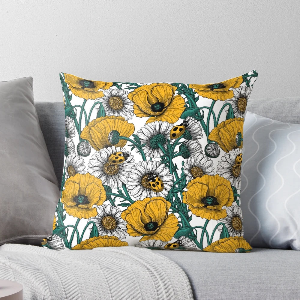 Close-up image of a decorative pillow featuring a vibrant yellow and white floral pattern inspired by a countryside meadow.