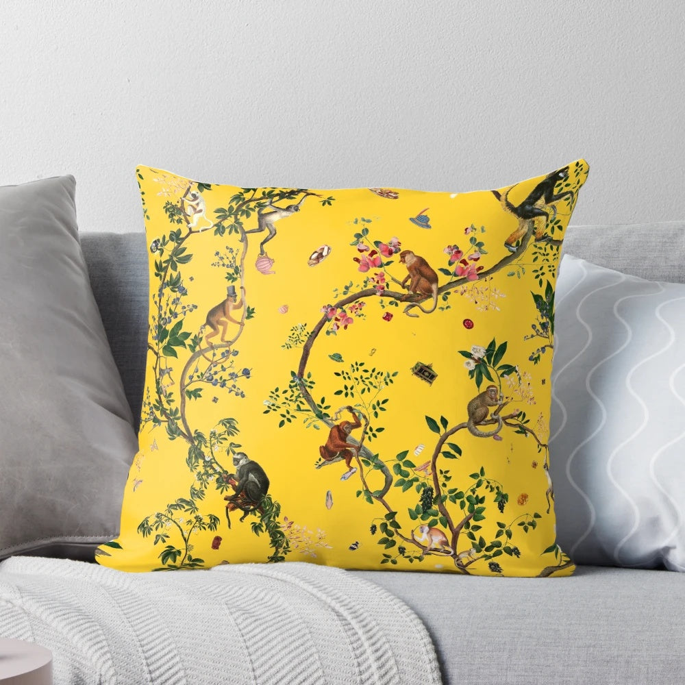 Closeup of a yellow pillow with a vibrant monkey and floral design, perfect for tropical-themed home decor.