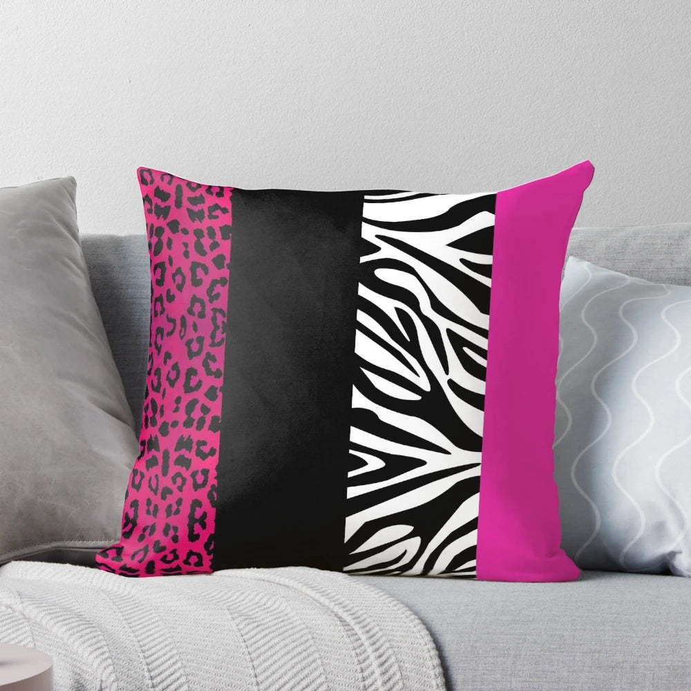 Colorful throw pillow with hot pink, black, and white animal print stripes
