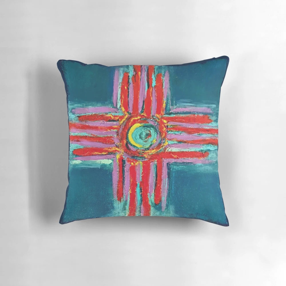 Decorative pillow featuring a textured zia symbol design in a blend of vibrant teal, lavender, and red colors.