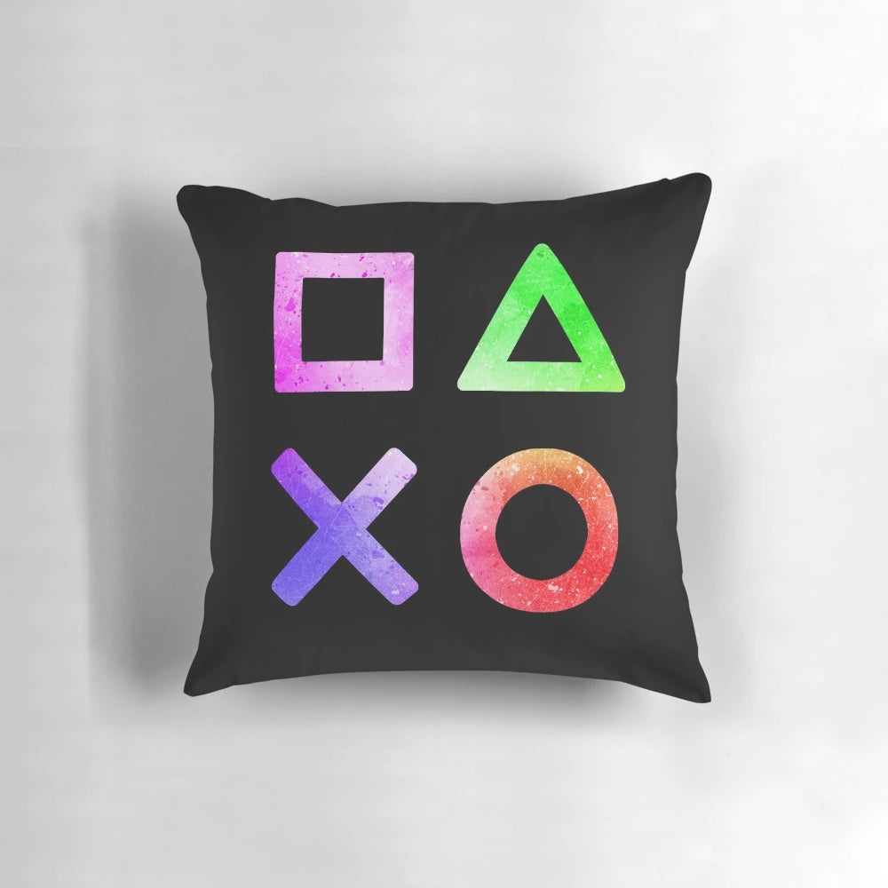 A colorful pillow featuring the iconic buttons and joystick of a video game controller, ideal for gaming enthusiasts.