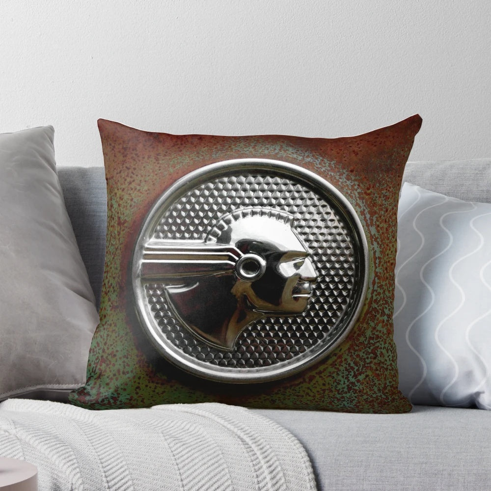 Vintage abandoned 1952 Pontiac Chieftain emblem pillow with rustic, patina-ed chrome and native american-inspired design
