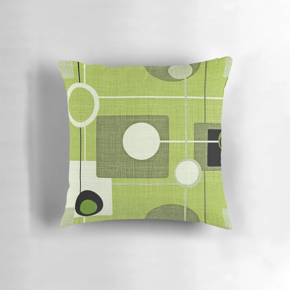 Vintage-inspired abstract throw pillow featuring a green and black orb and square pattern, perfect for modern and mid-century inspired home decor.