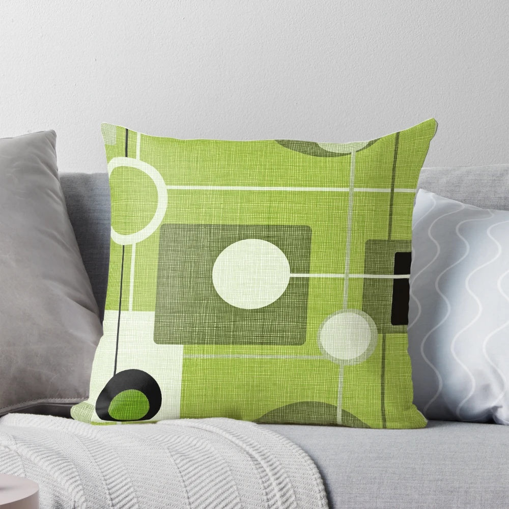 Vintage-inspired abstract throw pillow featuring a green and black orb and square pattern, perfect for modern and mid-century inspired home decor.