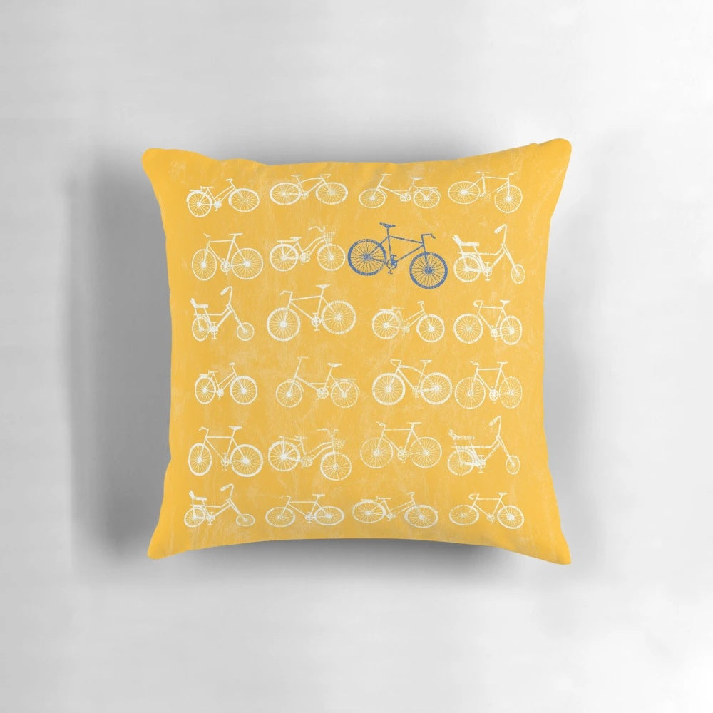 Vintage bicycle art pillow with a distressed, grunge design featuring a blue and white bicycle against a yellow background.