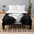 Vintage black and white portrait of Marilyn Monroe on a plush blanket