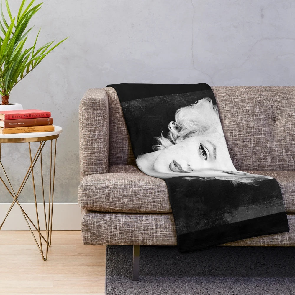 Vintage black and white portrait of Marilyn Monroe on a plush blanket
