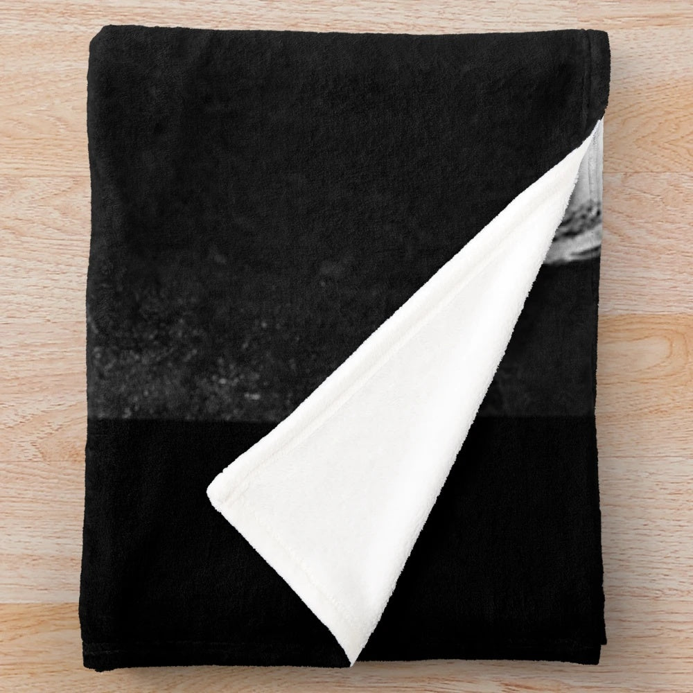 Vintage black and white portrait of Marilyn Monroe on a plush blanket