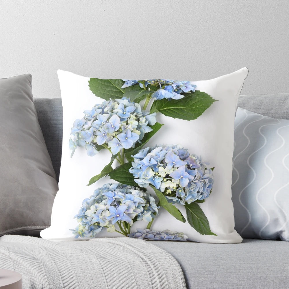 A beautiful bouquet of blue hydrangea flowers on a decorative throw pillow