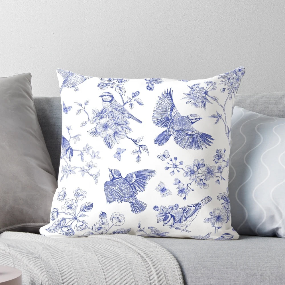 Vintage blue and white toile pattern pillow with delicate bird design, perfect for French country style home decor.