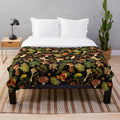 Vintage botanical pattern with psychedelic mushrooms on a black plush blanket