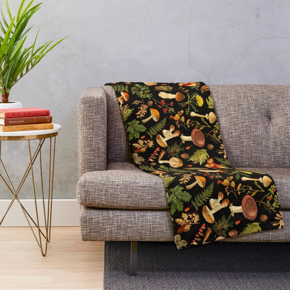 Vintage botanical pattern with psychedelic mushrooms on a black plush blanket