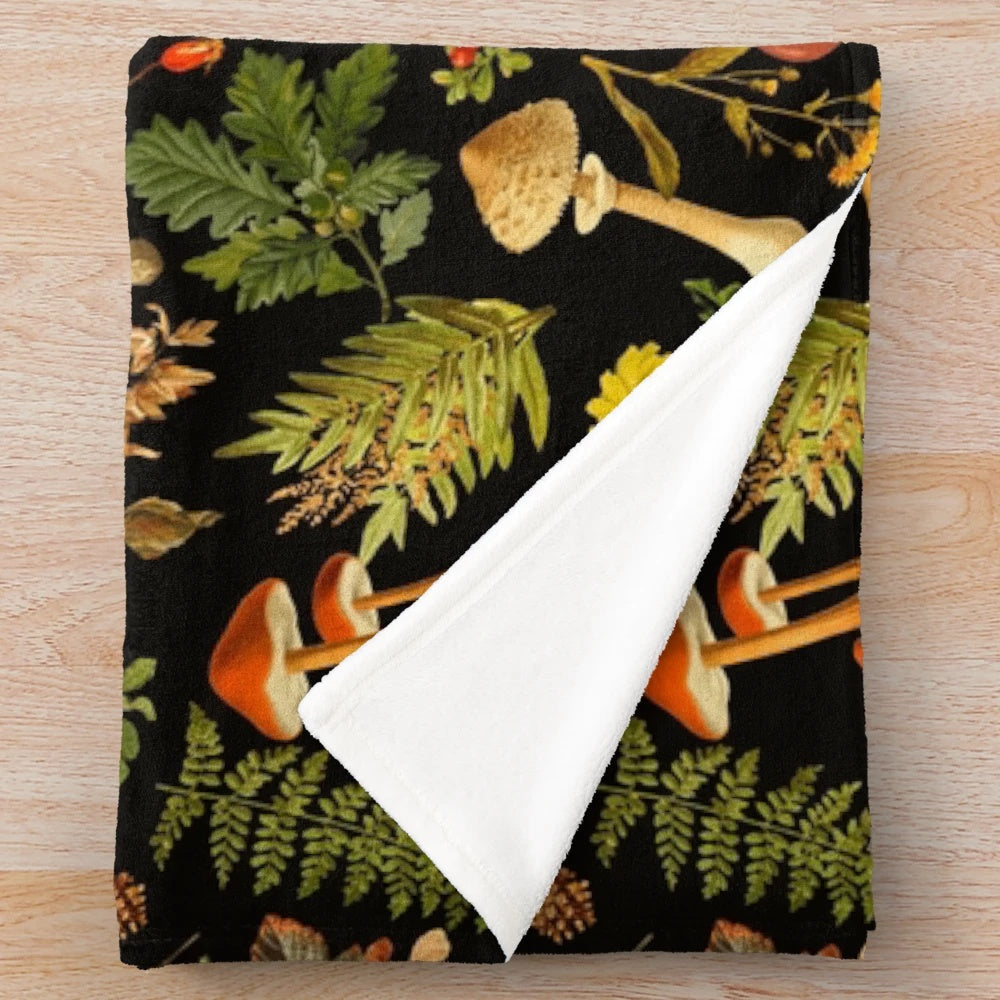 Vintage botanical pattern with psychedelic mushrooms on a black plush blanket
