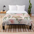 Vintage botanical plush blanket featuring a pattern of blush pink peony flowers