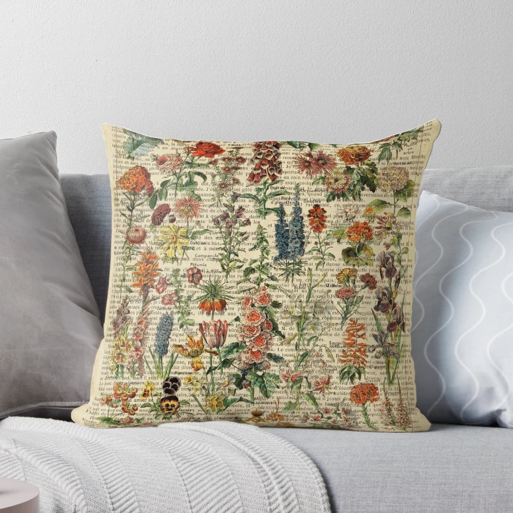 Vintage botanical print pillow featuring iris and garden flowers on an aged book page