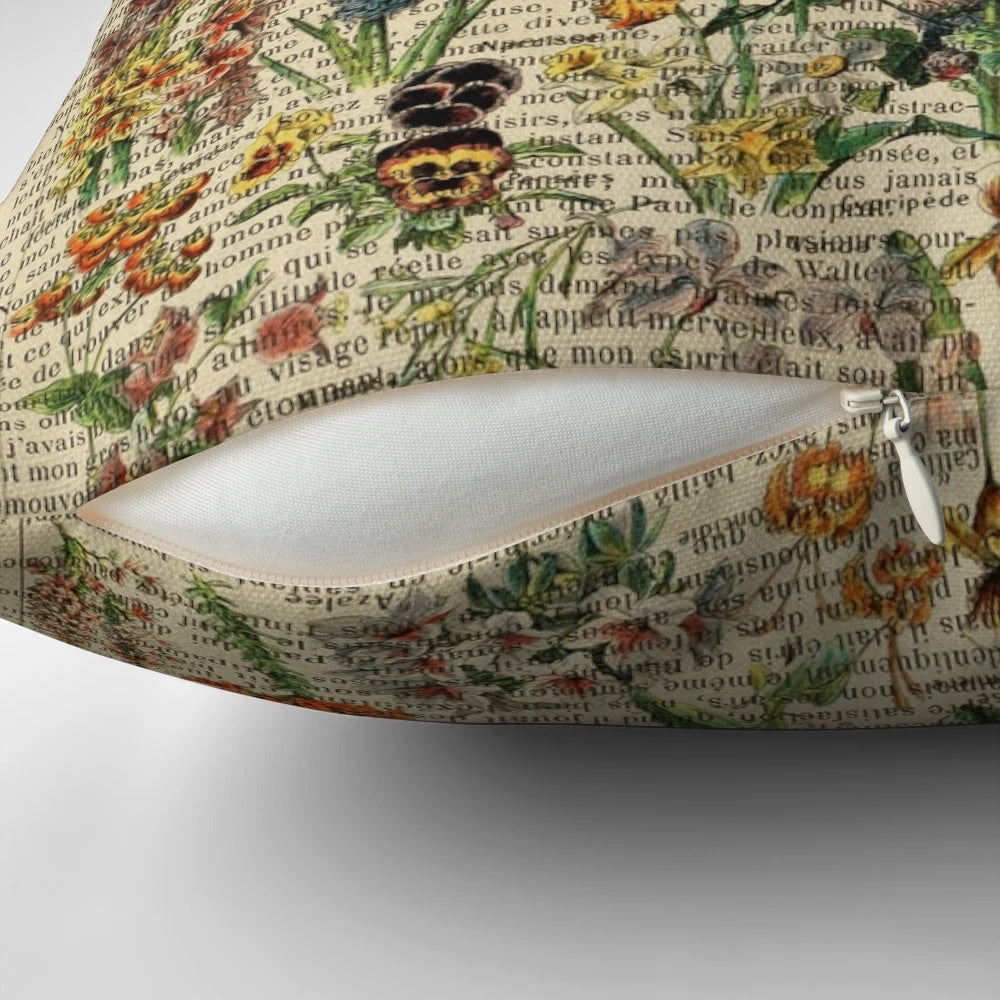 Vintage botanical print pillow featuring iris and garden flowers on an aged book page