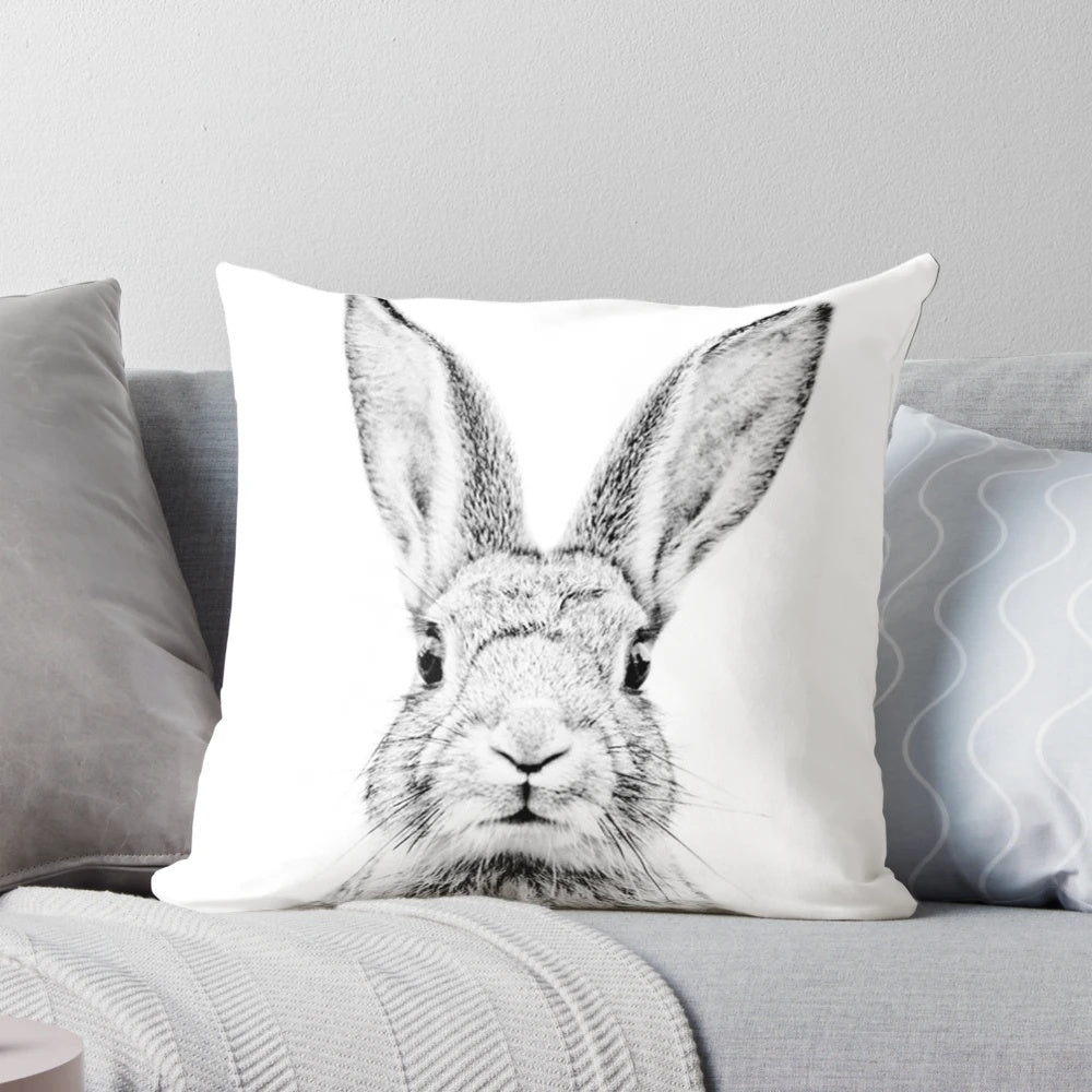 Vintage-style minimalist line drawing of a bunny on a white background, printed on a decorative pillow.