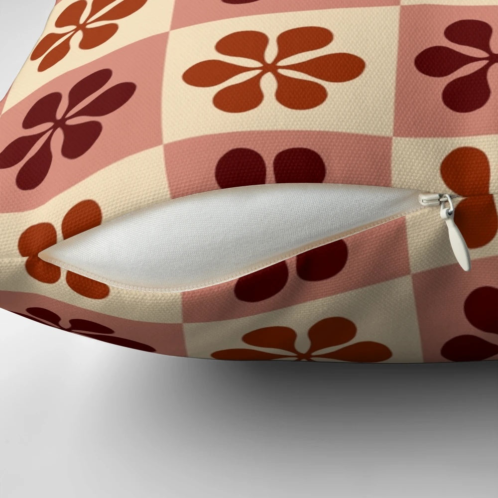 Burgundy and mauve checkerboard pattern pillow with a vintage floral design, perfect for adding a touch of retro style to any room.