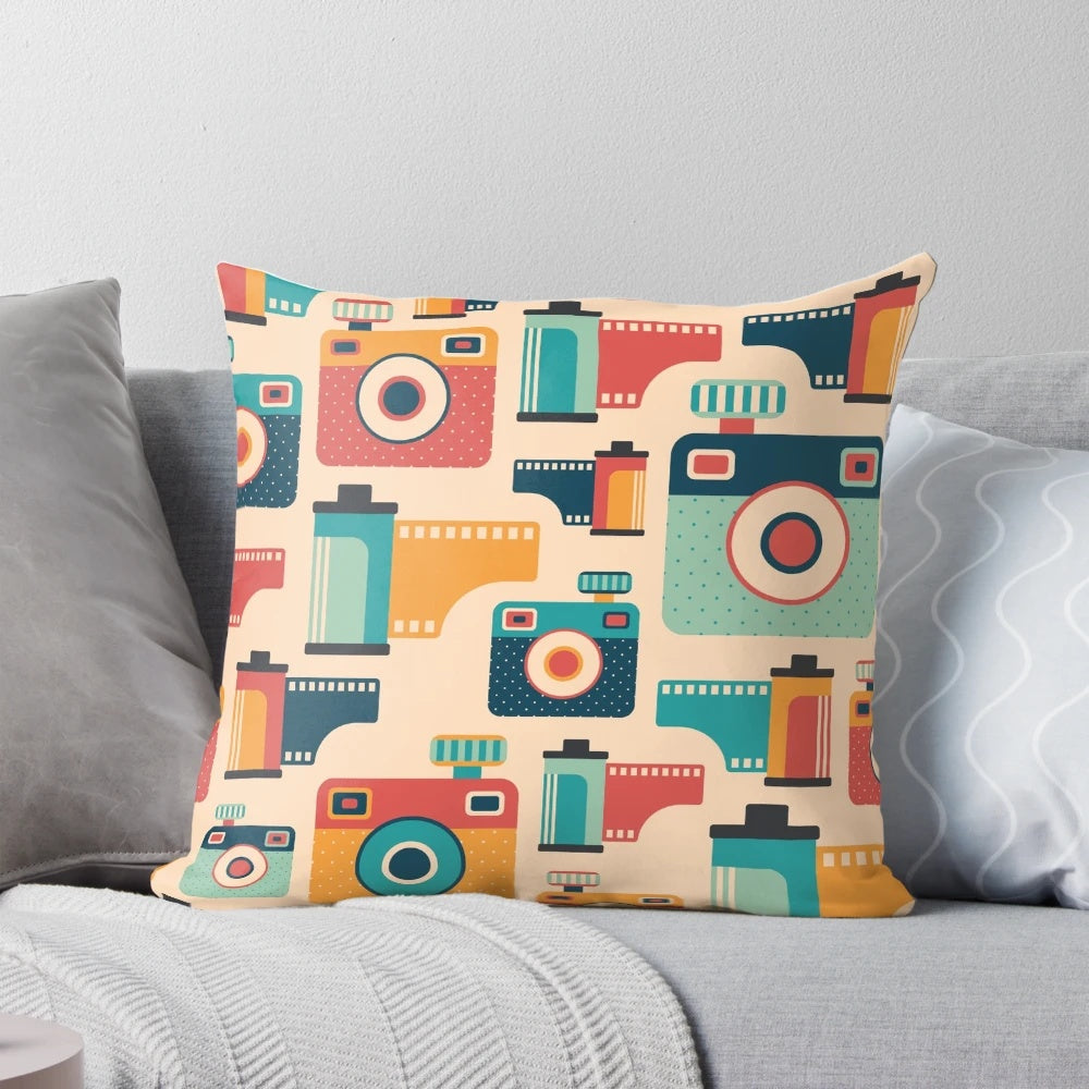 Throw pillow with a vintage camera and film roll graphic design, perfect for home decor and photography enthusiasts.