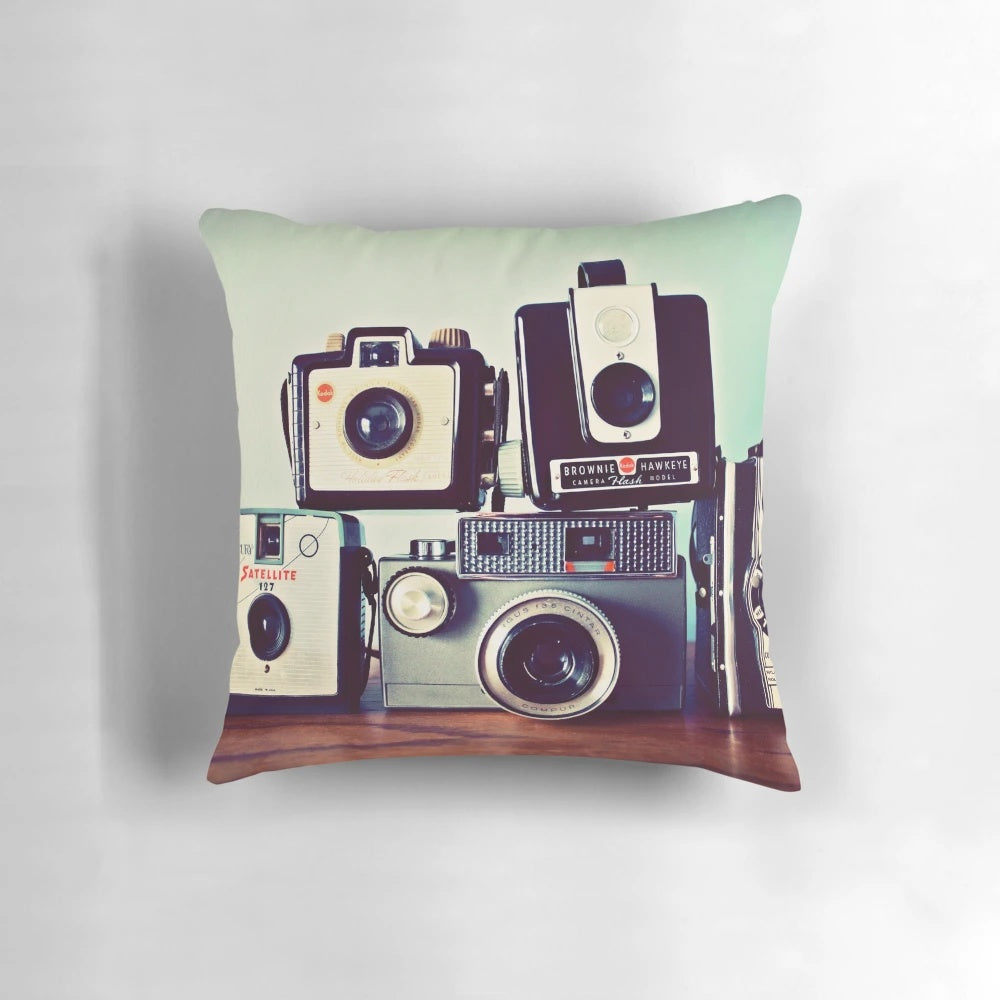 Vintage camera-themed decorative pillow featuring a collage of retro film cameras and photography equipment
