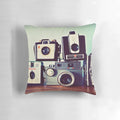 Vintage camera-themed decorative pillow featuring a collage of retro film cameras and photography equipment
