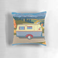 A decorative pillow featuring a vintage-inspired caravan illustration with a schnauzer accent.