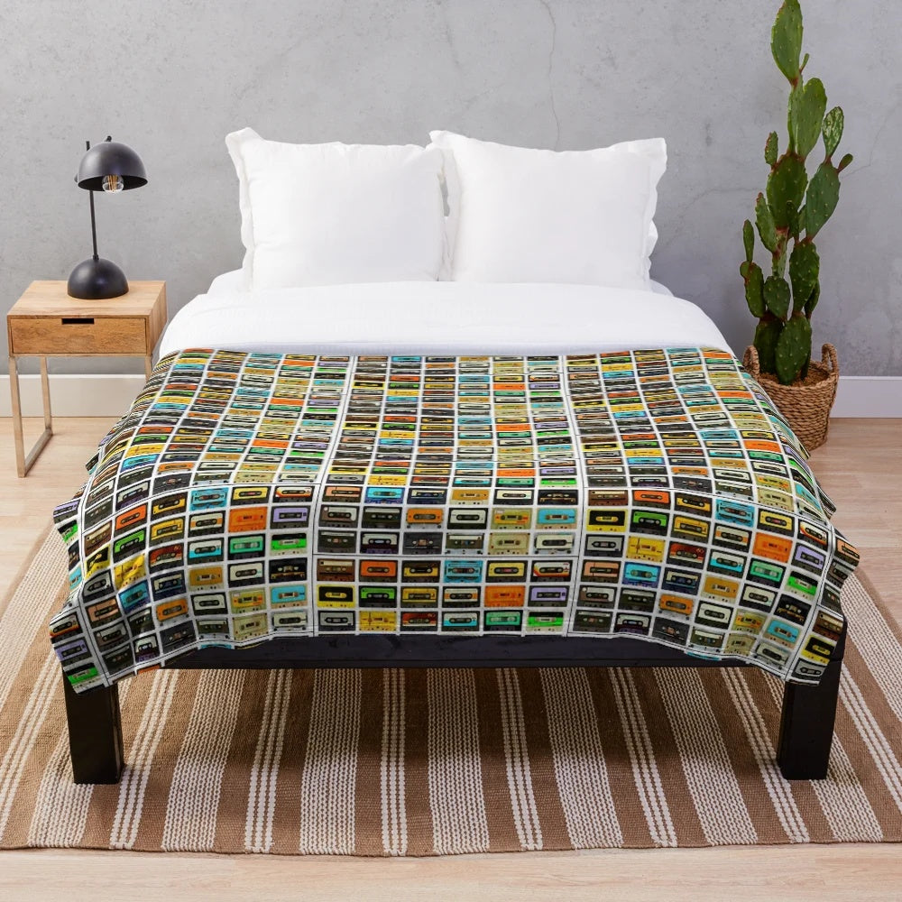 Plush blanket featuring a montage of 1980's cassette tapes and audio equipment