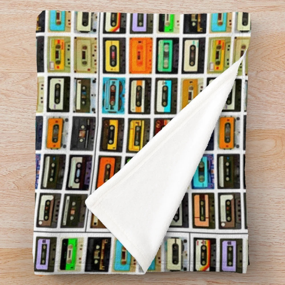 Plush blanket featuring a montage of 1980's cassette tapes and audio equipment