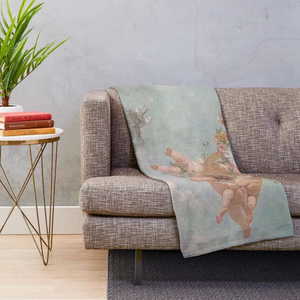 Vintage-inspired plush blanket with cherub and renaissance cloud design