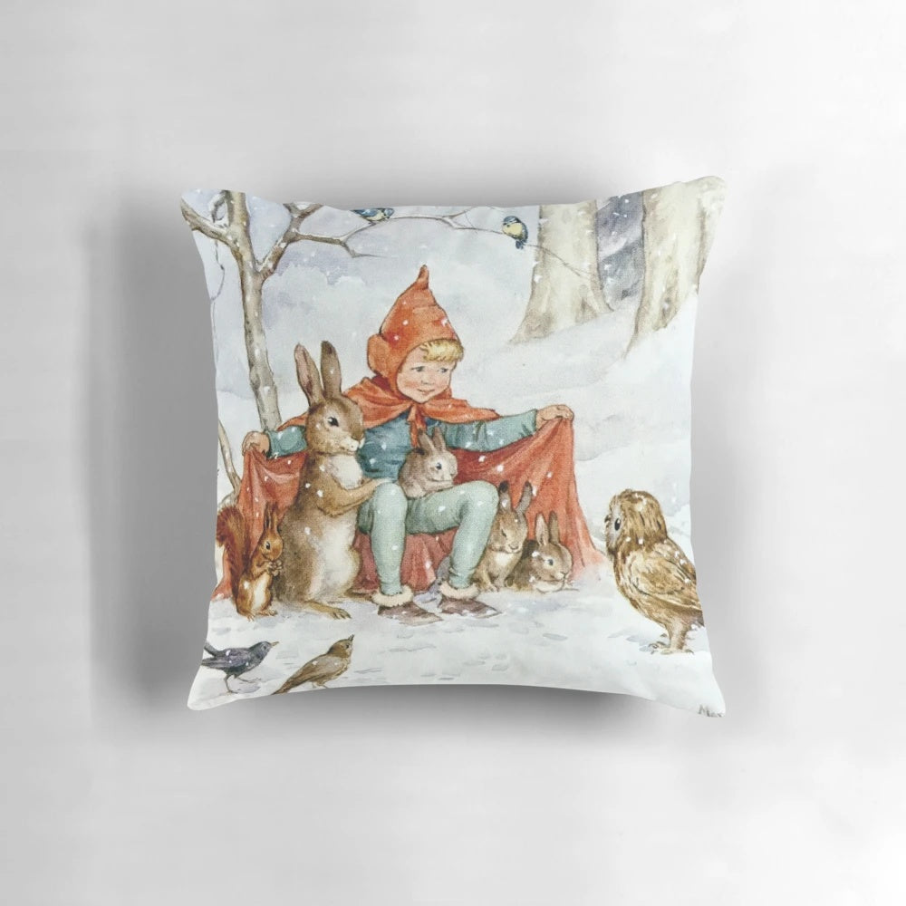 Vintage-style pillow featuring a cozy winter scene with woodland animals in a snowy forest, illustrated by renowned artist Margaret Tarrant.
