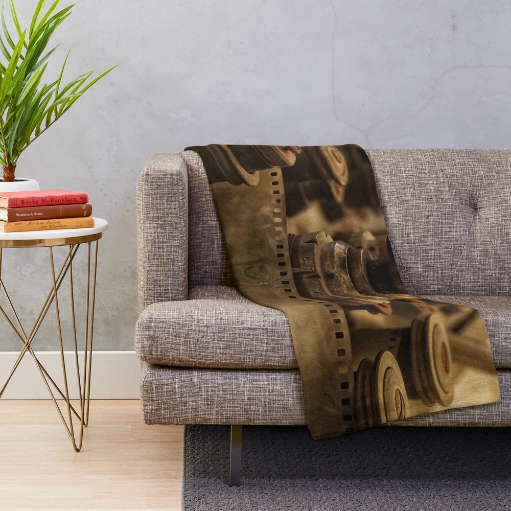 Vintage cinema-themed plush blanket with old camera and movie projector elements