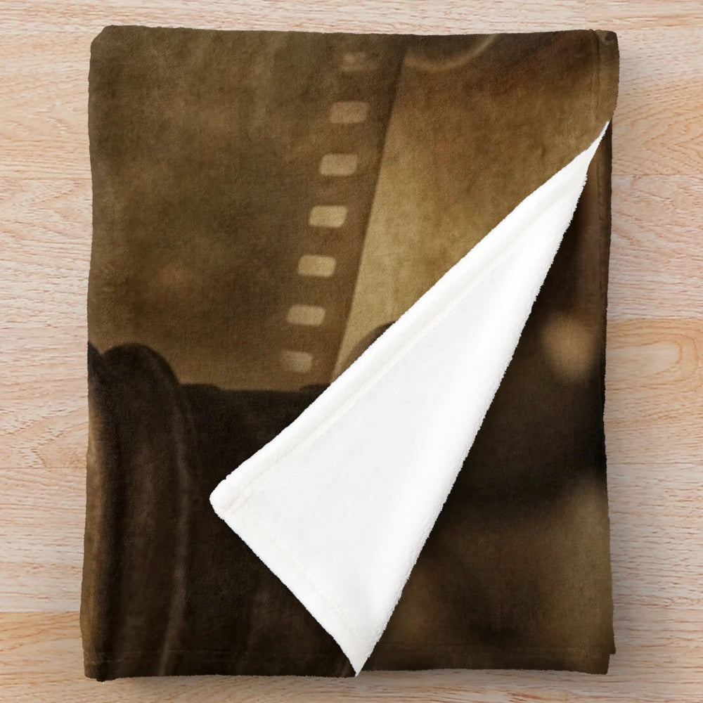 Vintage cinema-themed plush blanket with old camera and movie projector elements