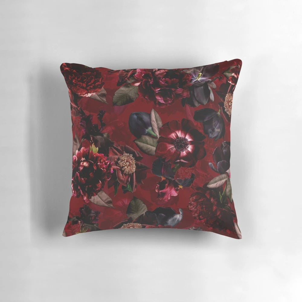 Dark red roses in a lush, botanical midnight garden printed on a soft, cozy pillow