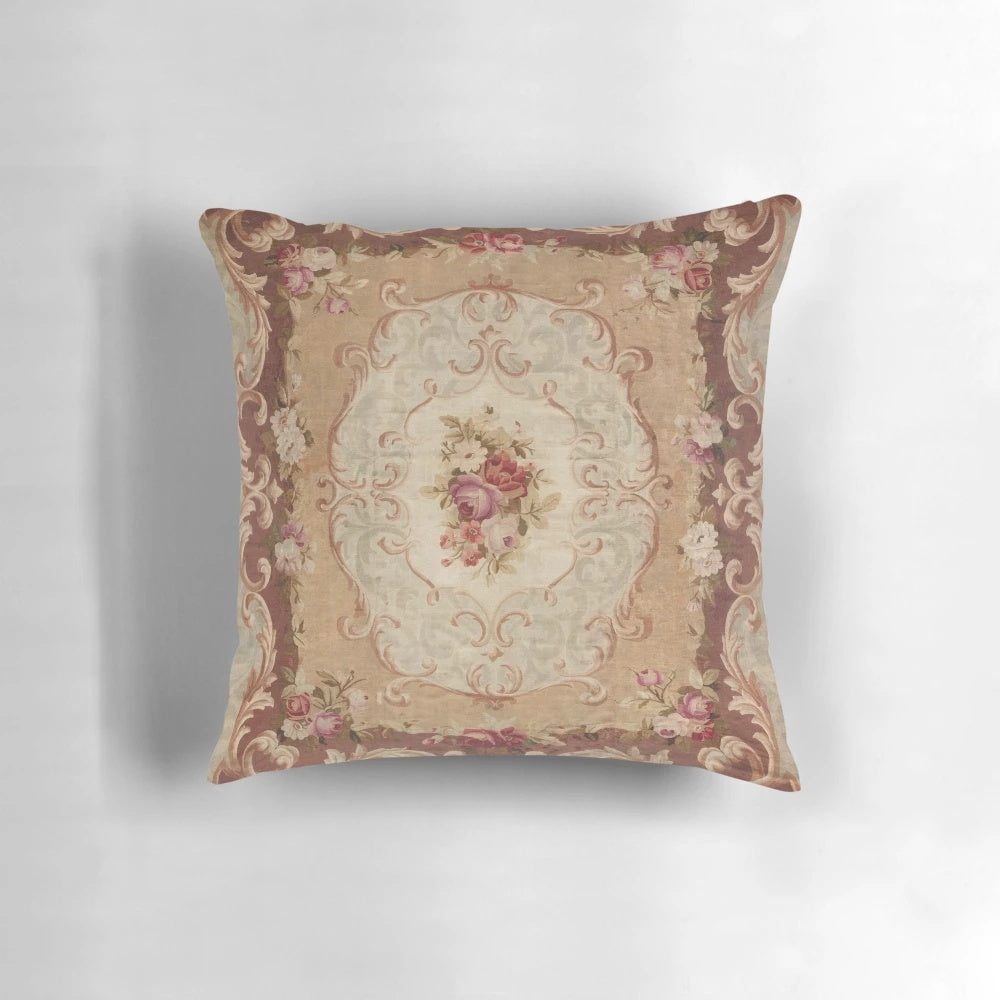 Vintage-inspired floral print pillow with an Aubusson-style design, featuring roses, daisies, and leaves in shades of brown and beige.