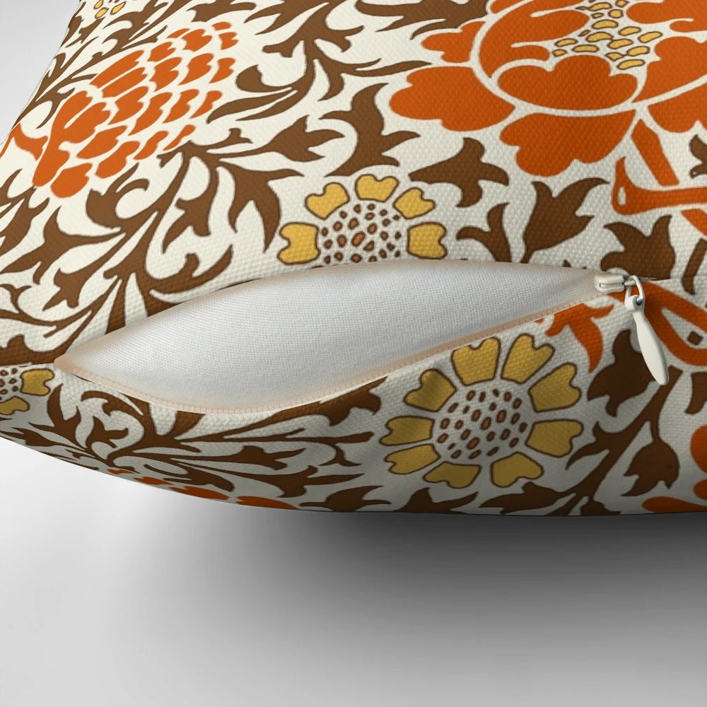 Jacobean floral wallpaper pattern featuring mandarin orange, mustard gold, and brown colors on a parchment background, printed on a decorative throw pillow.
