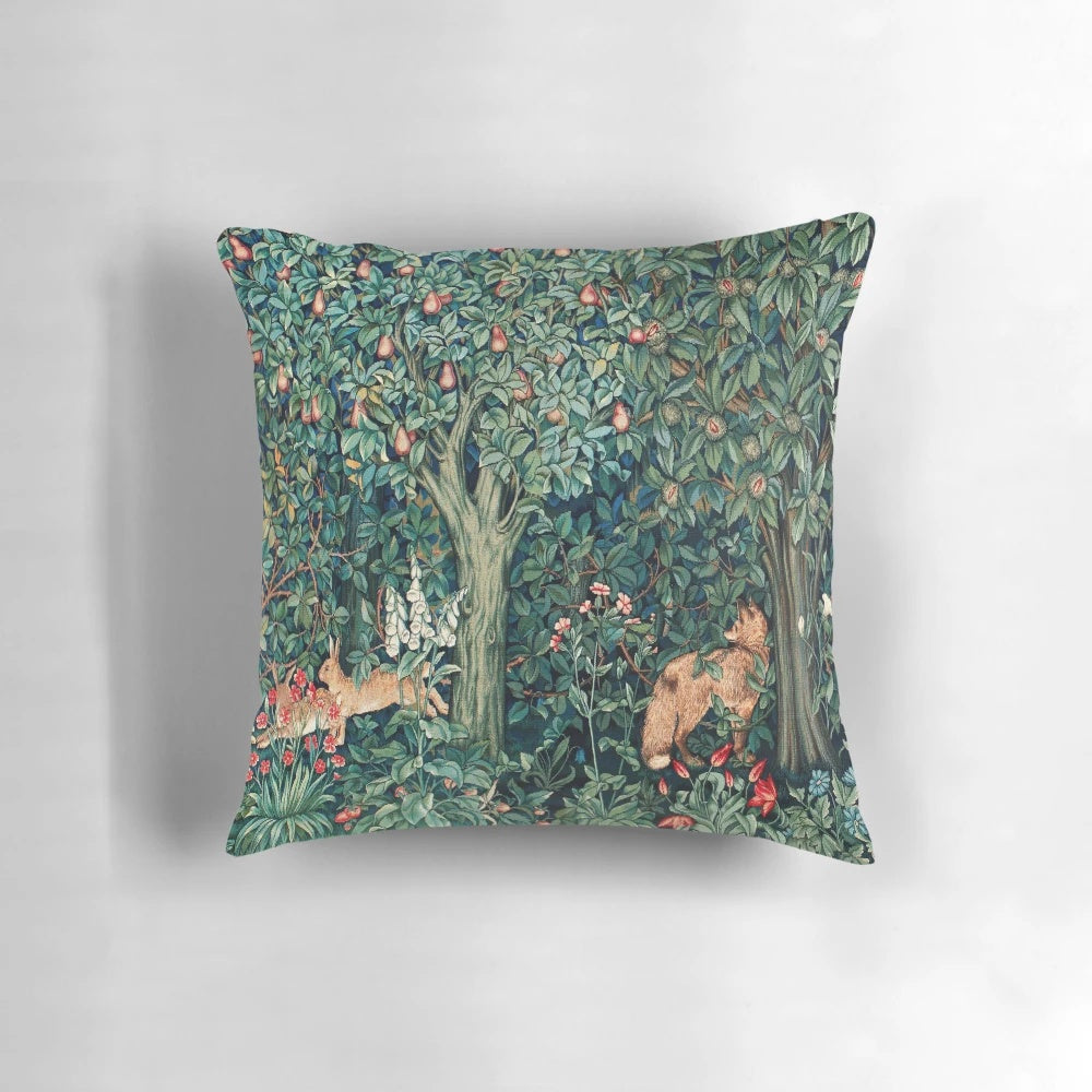 Vintage green and blue floral tapestry pillow with foxes and hares in a forest setting