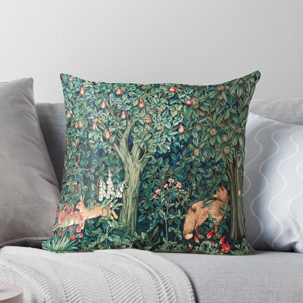 Vintage green and blue floral tapestry pillow with foxes and hares in a forest setting