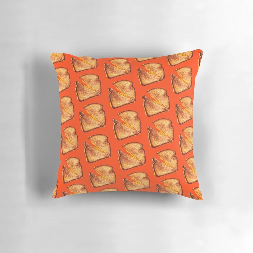 A red throw pillow featuring a vintage-inspired grilled cheese sandwich pattern design.