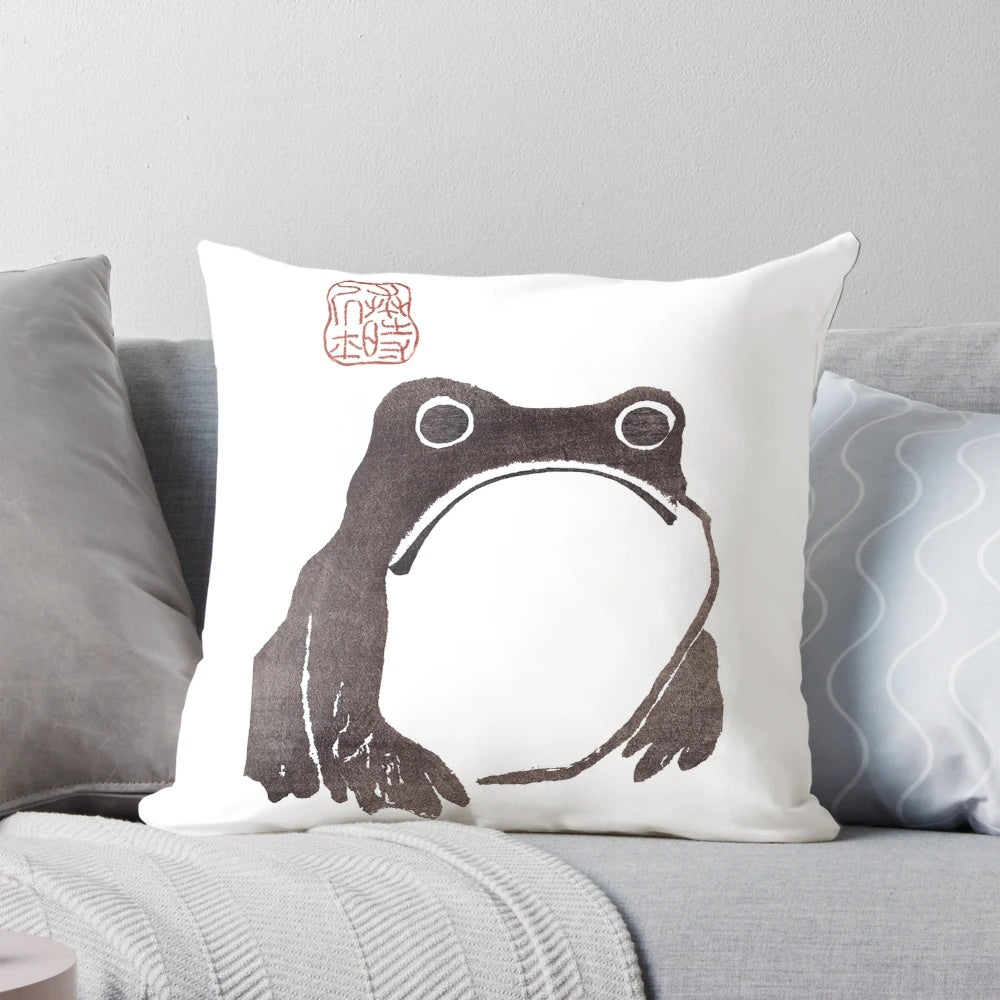 Vintage-style sketch of a grumpy frog on a decorative pillow